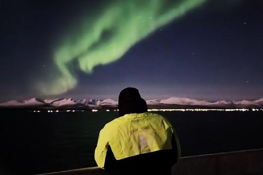 Passenger looking at the northern lights