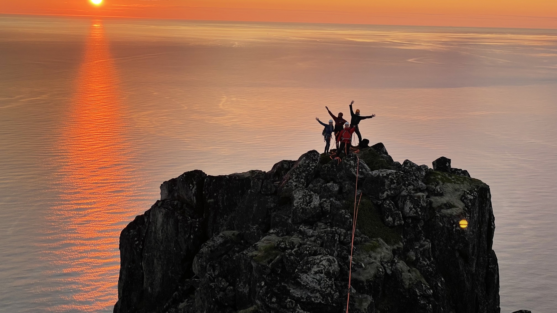 Climbers on a mountain in sunset