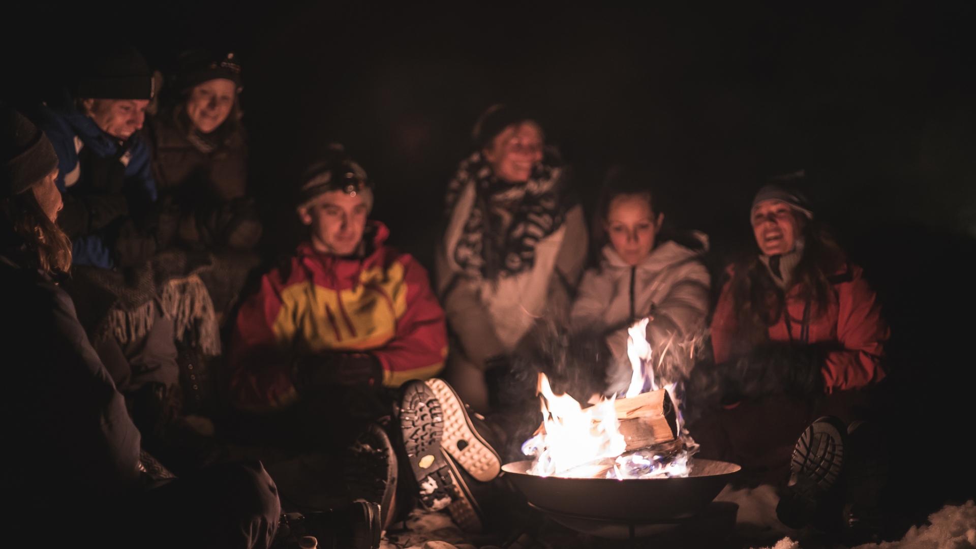 people sitting around a bonfire