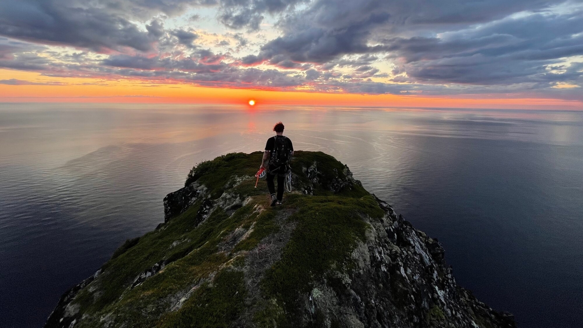 Climber viewing the sunset from a mountain