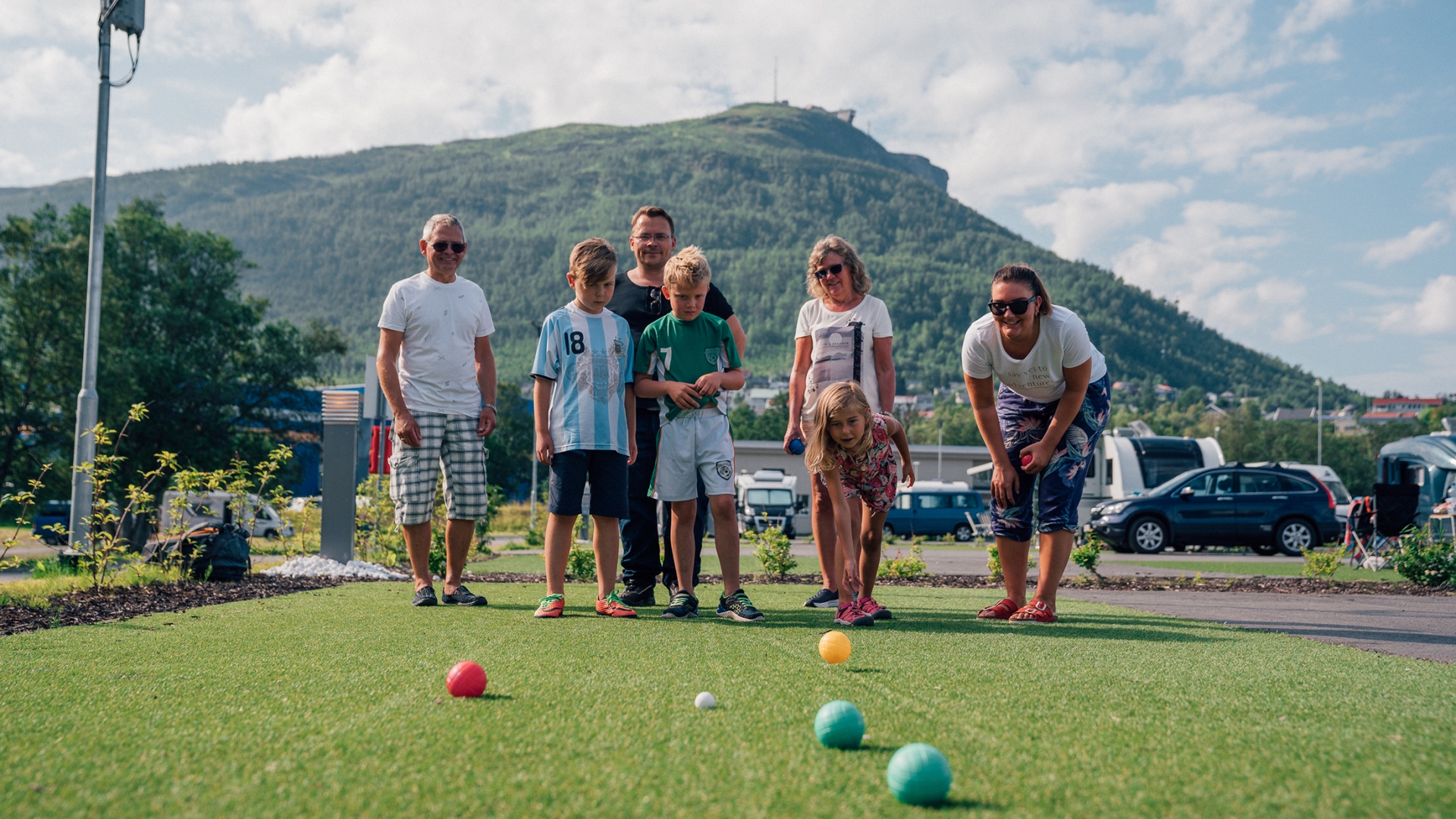 Family playing boccia at Tromsø camping