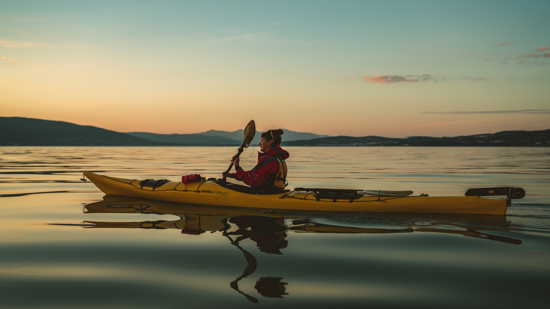 Woman kayaking in the sunset