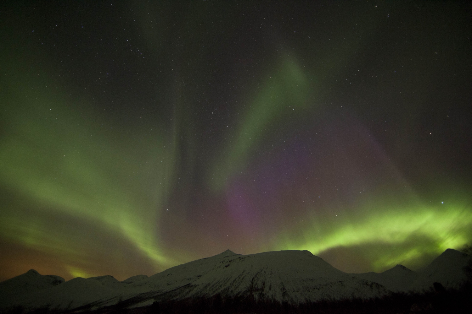 Northern lights above mountains
