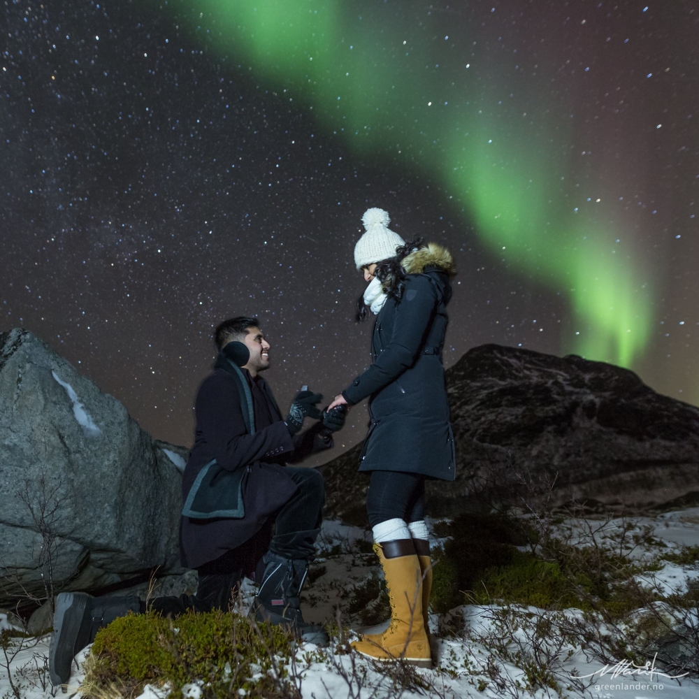 man proposing under the northern lights