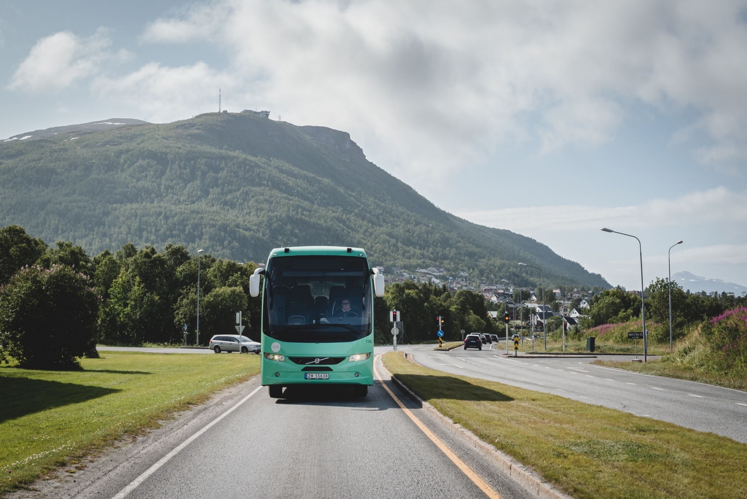 Bus on the road, mountain in the background
