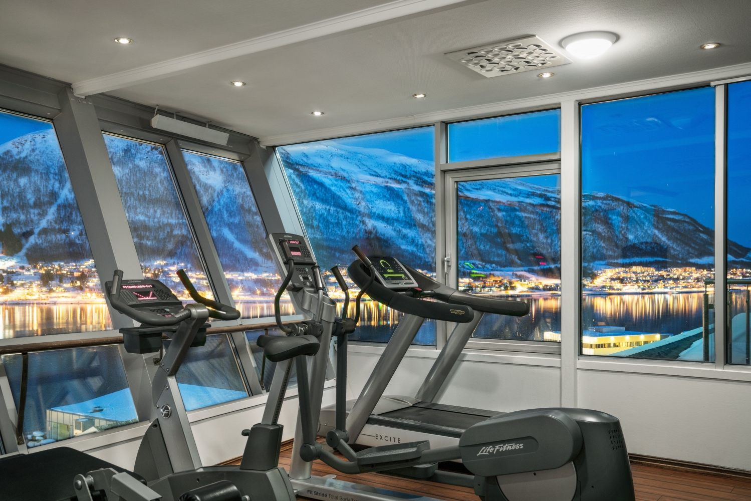 a gym with treadmils and an amazing view