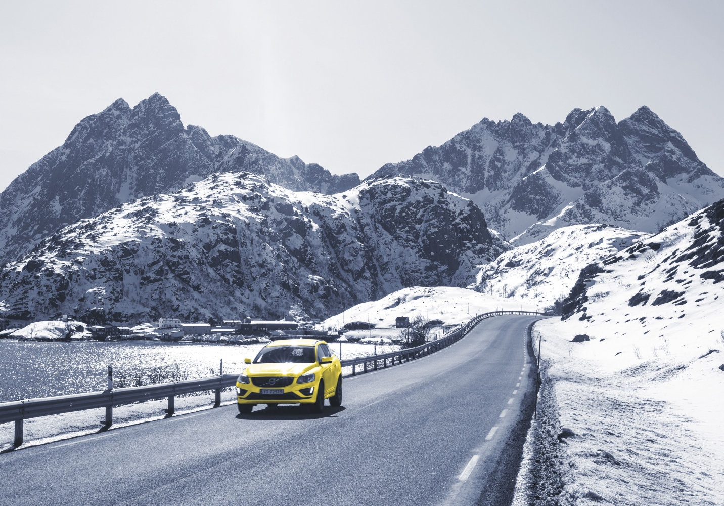 yellow car driving in wintertime by the sea