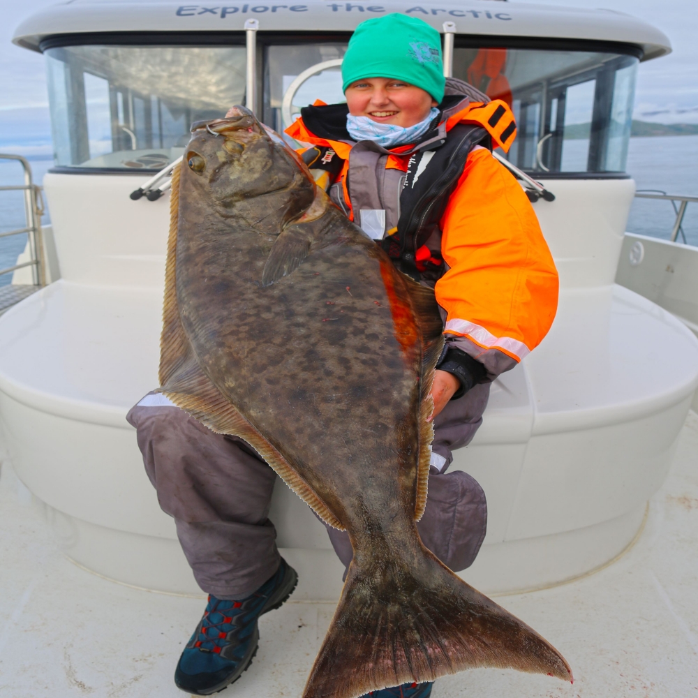 Person holding a halibut