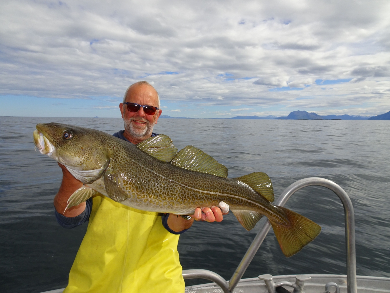 guest with big cod on a fishing trip