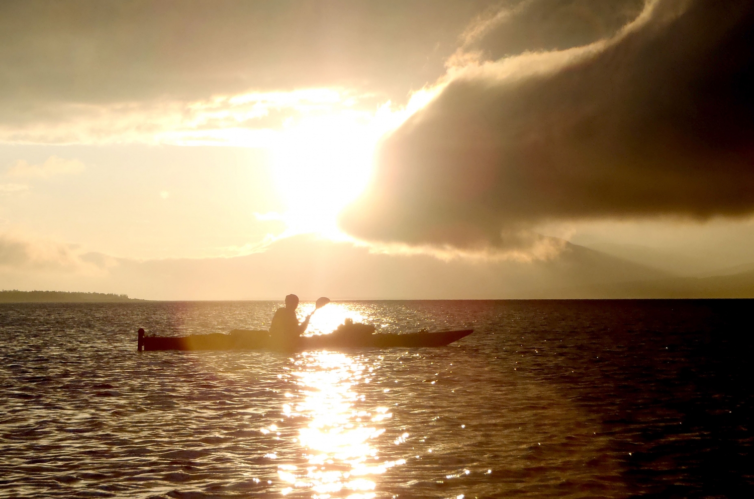 Person kayaking in the light from the Midnight Sun