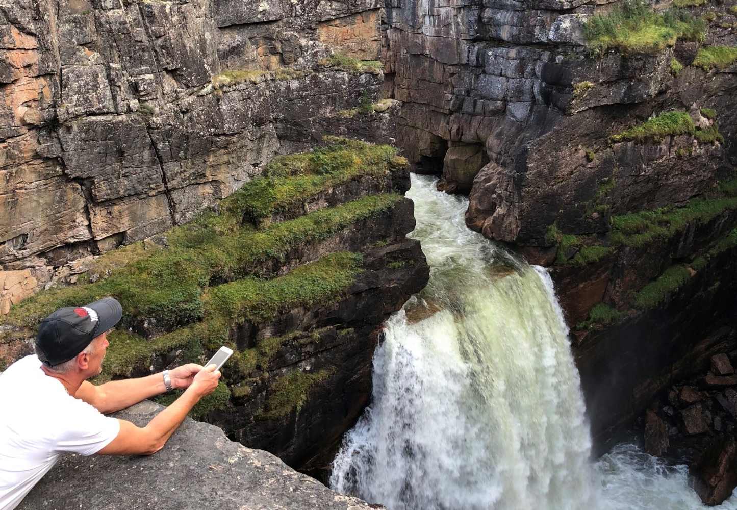 person looking at a waterfall