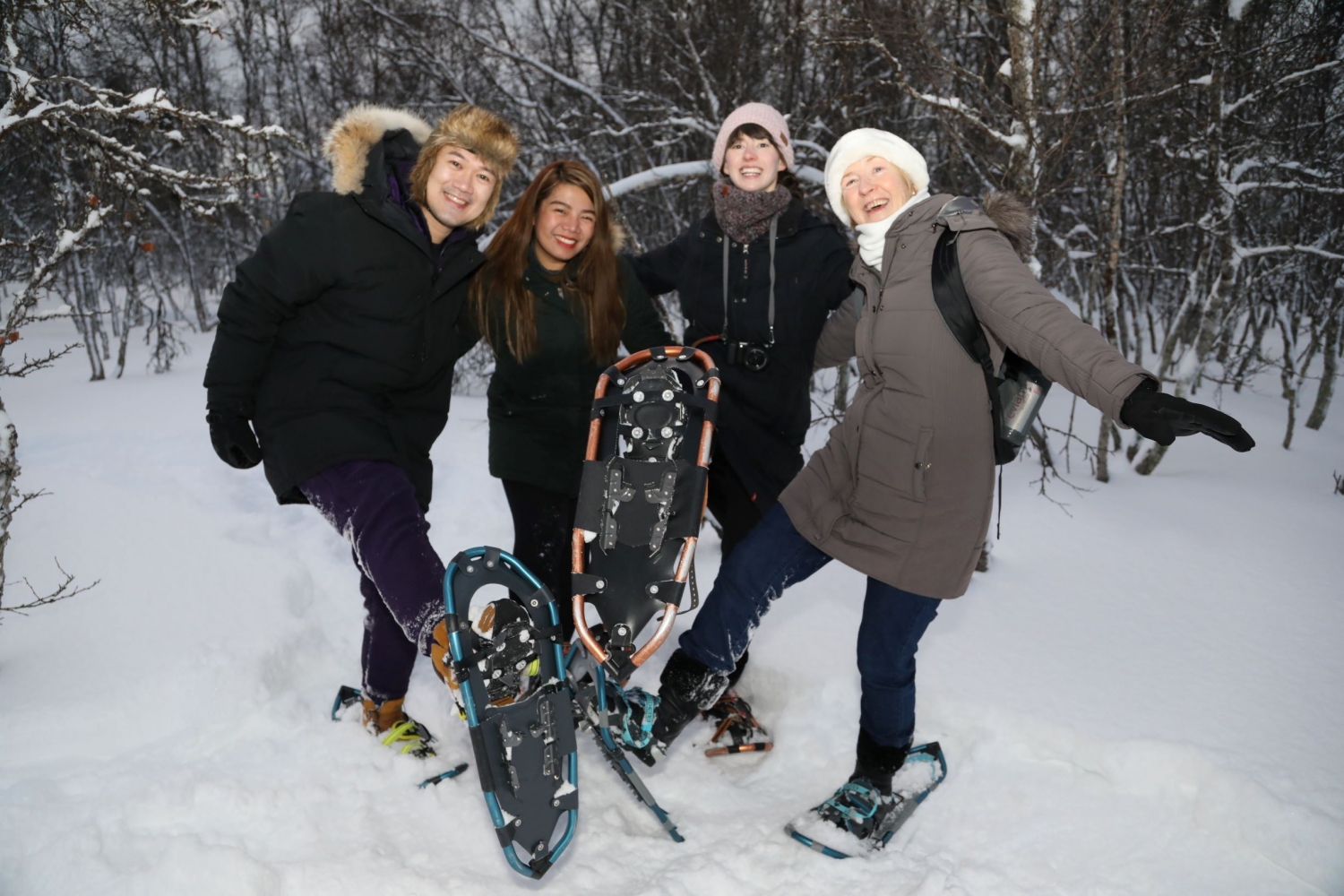 four people snowshoeing