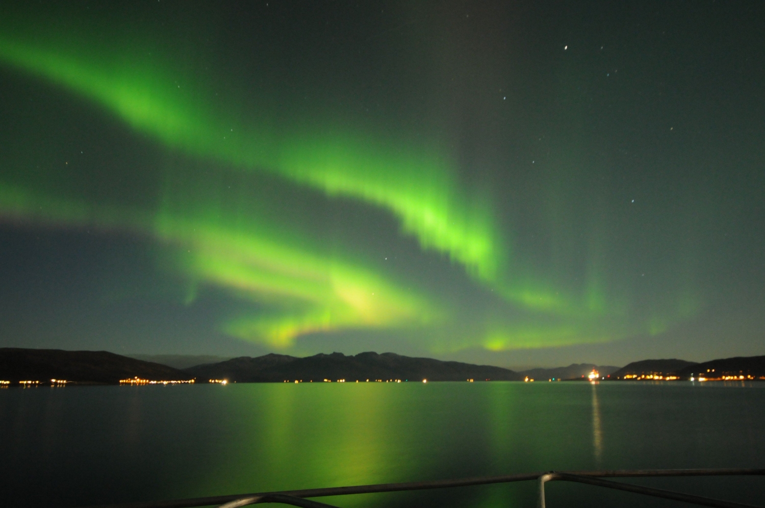 Northern Lights above the sea and mountains