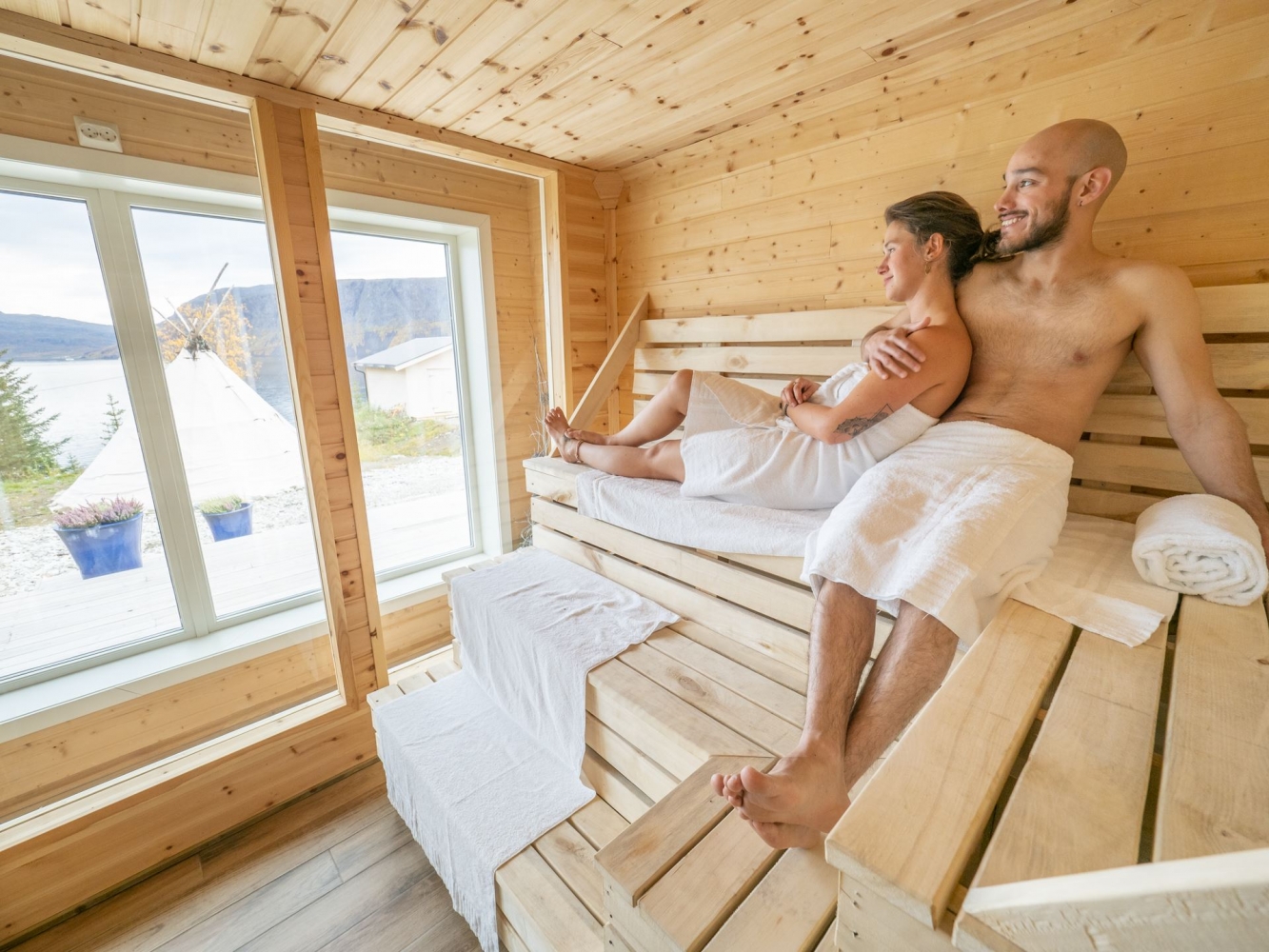 two people sitting in a sauna