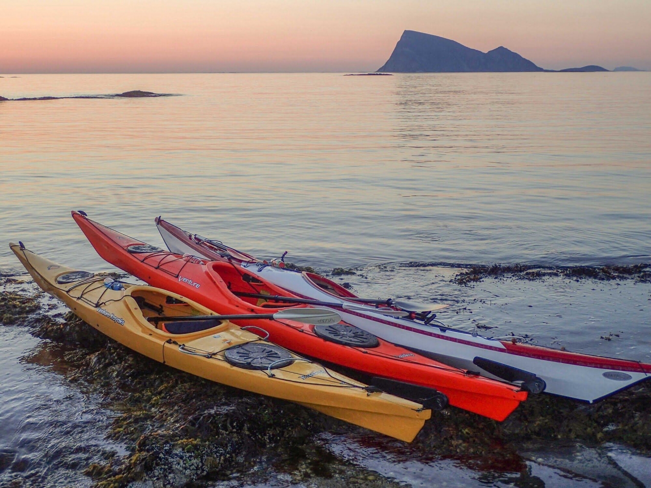 kayak on a beach with views towards the open sea and the mountain Håja