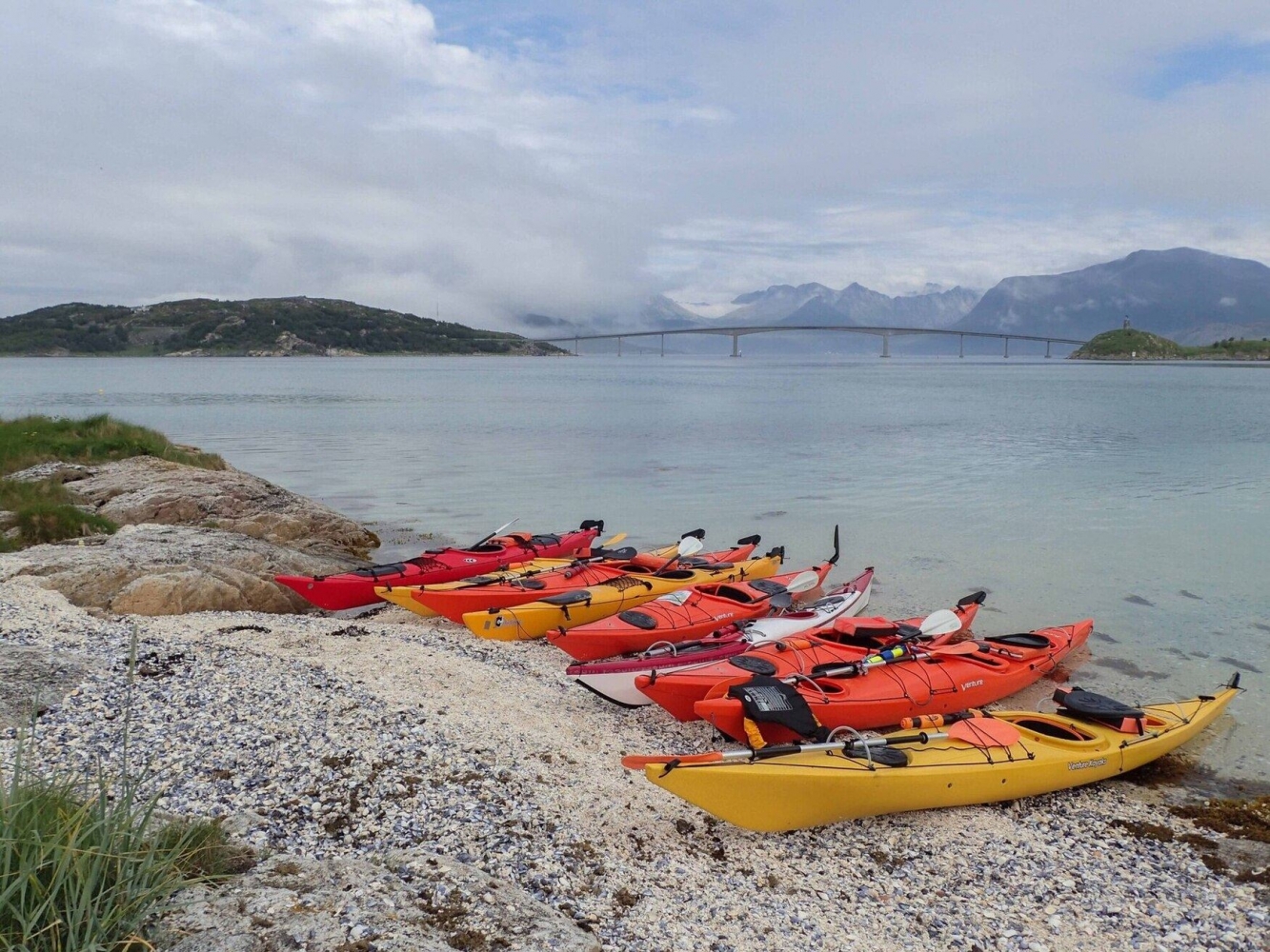 kayaks on a beach with views towards the bridge over to Sommarøy