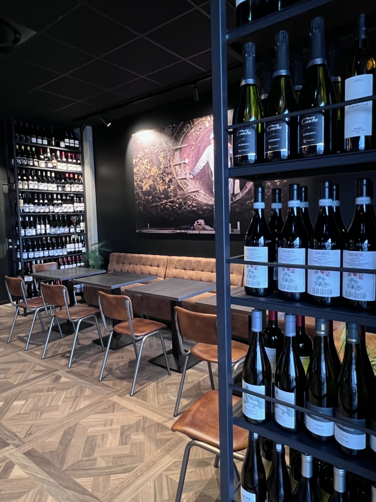 Wine bottles around in the bar on shelves and seatings