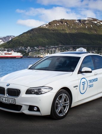 white bmw with the bridge and hurtigruten in the background