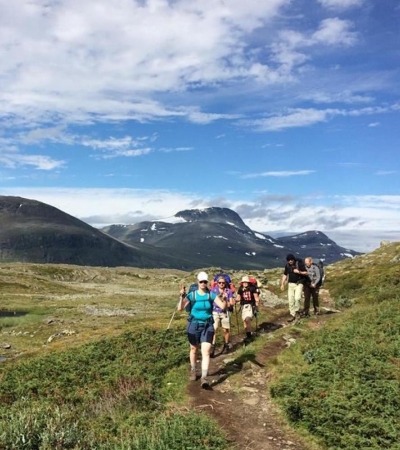 People hiking in mountains in Narvik