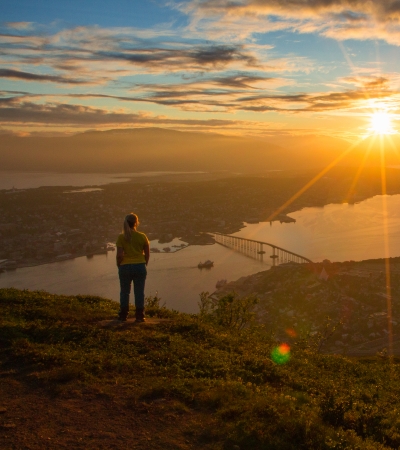 Women watching the Midnight sun over Tromsø island from the Sherpa steps