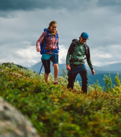 Man and woman hiking in mountain in Målselv