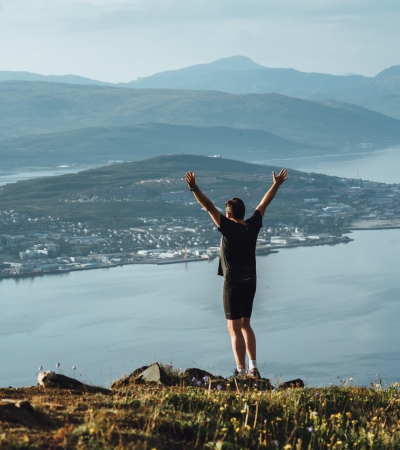Man standing at viewpoint over Tromsø island