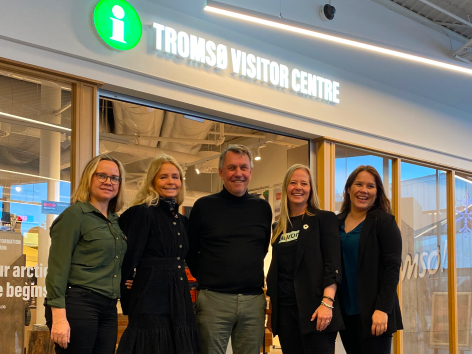 Group smiling in front of Tromsø Visitor Centre