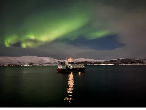 MS Havcruise sailing beneath the Northern Lights near Tromsø