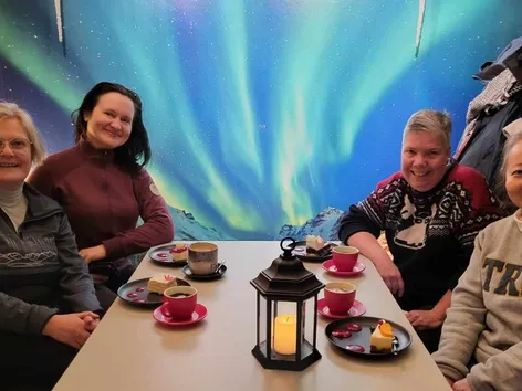 Four guests sitting around a table at a cafe