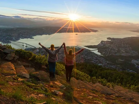 Two friends enjoying the view and the Midnight Sun from the Sherpa steps in Tromsø