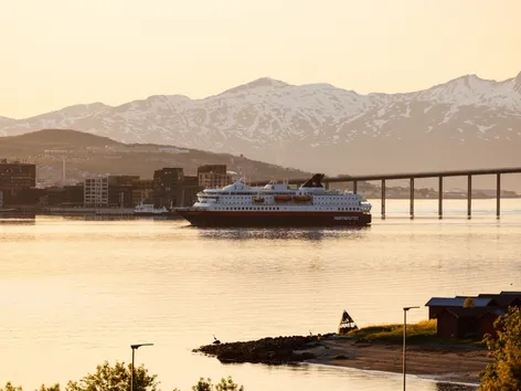 Coastal steamer sailing in the Tromsø sound during the midnight sun season.
