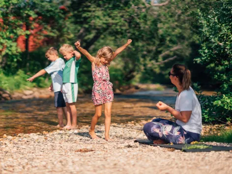 Family playing by the river at Tromsø camping