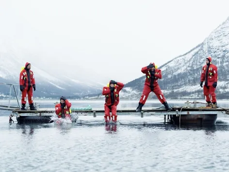 Five guests in flotation suits by the dock