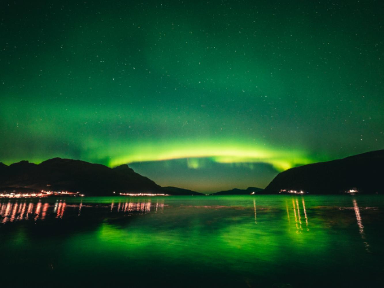 Northern lights above a fjord