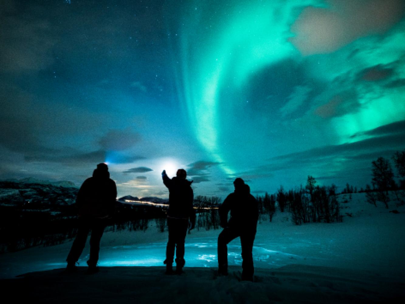 Watching the northern lights in Arctic winter landscape