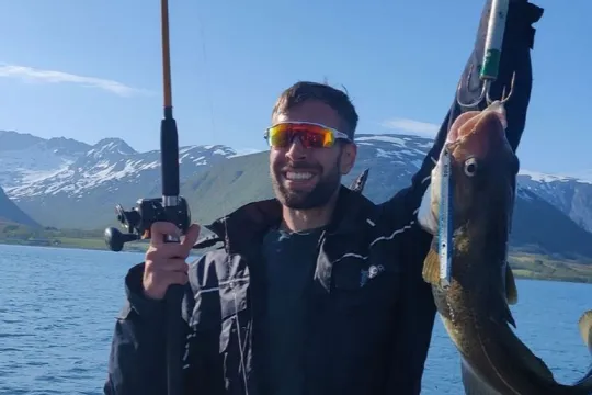 A guest shows off the fish he has caught