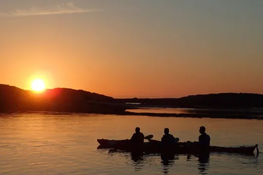Three people on one kayak