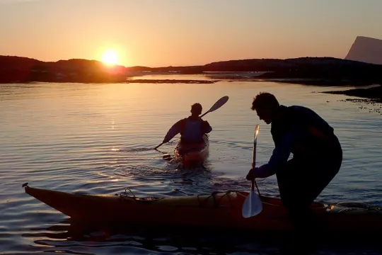 People preparing their kayak's in the midnight sun light