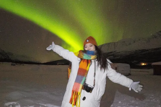 A guest standing under the northern lights