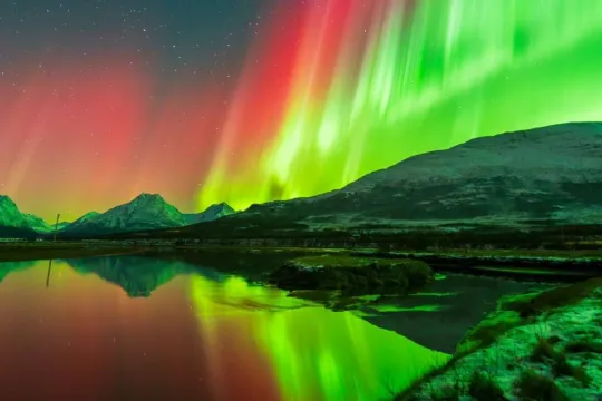 Northern Lights above snow covered mountains