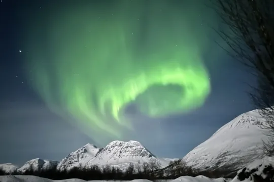 Northern lights and snow covered mountains
