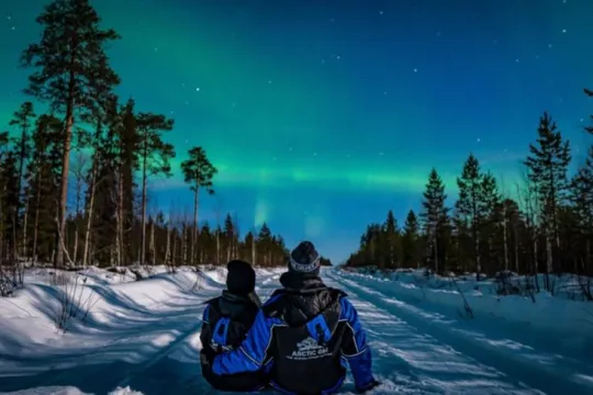 Two guests looking at the northern lights