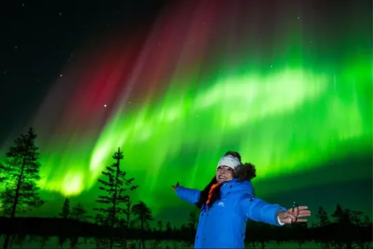 Guest posing with the northern lights