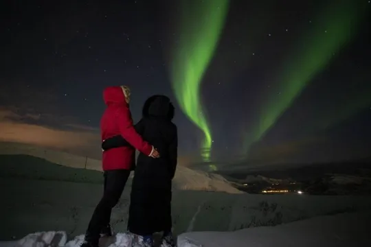 Two guests watching the Northern Lights