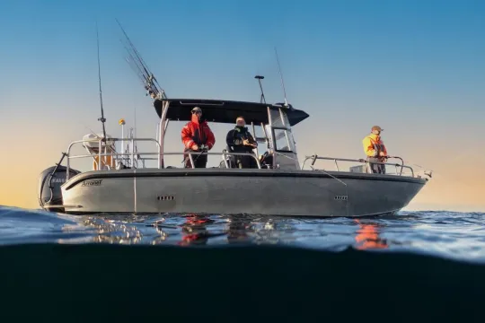 Several people fishing from a boat