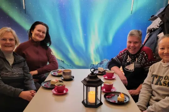 Four people sitting around a table at a café