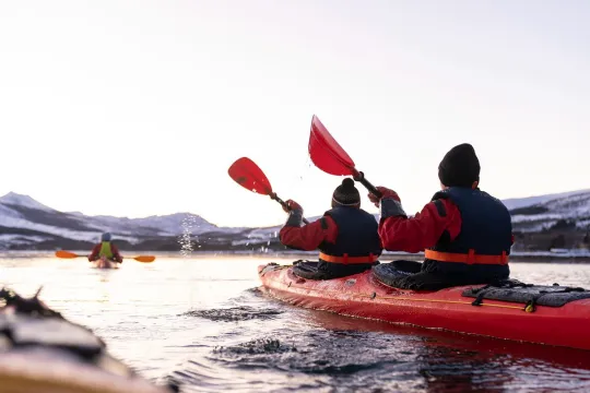 Guests steer the kayak down the lake