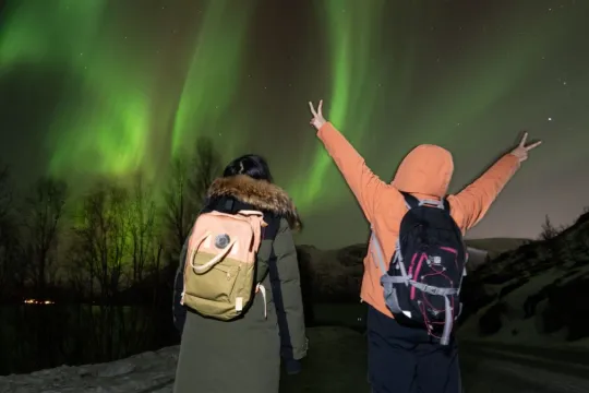 Guests look for the Northern Lights on a tour with Hello Tromsø outside Tromsø.