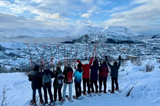 A group of guests on a snowshoe walk through the snow-covered landscape around Skjervøy.