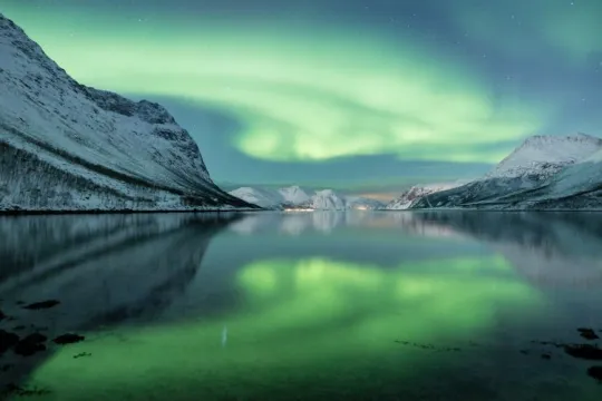 Northern lights over a fjord